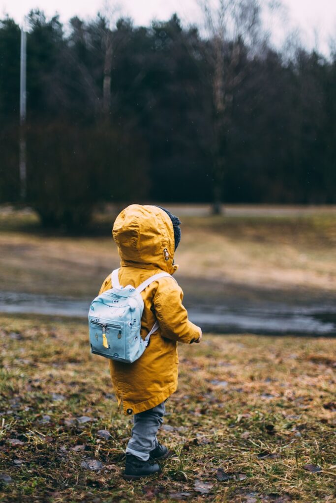 shallow focus photo of toddler traveling near river