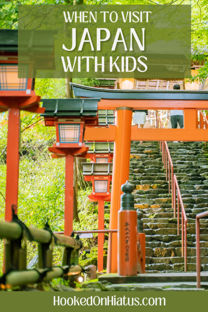 When to visit Japan with kids. Torii gate near stairs covered in lush green. 