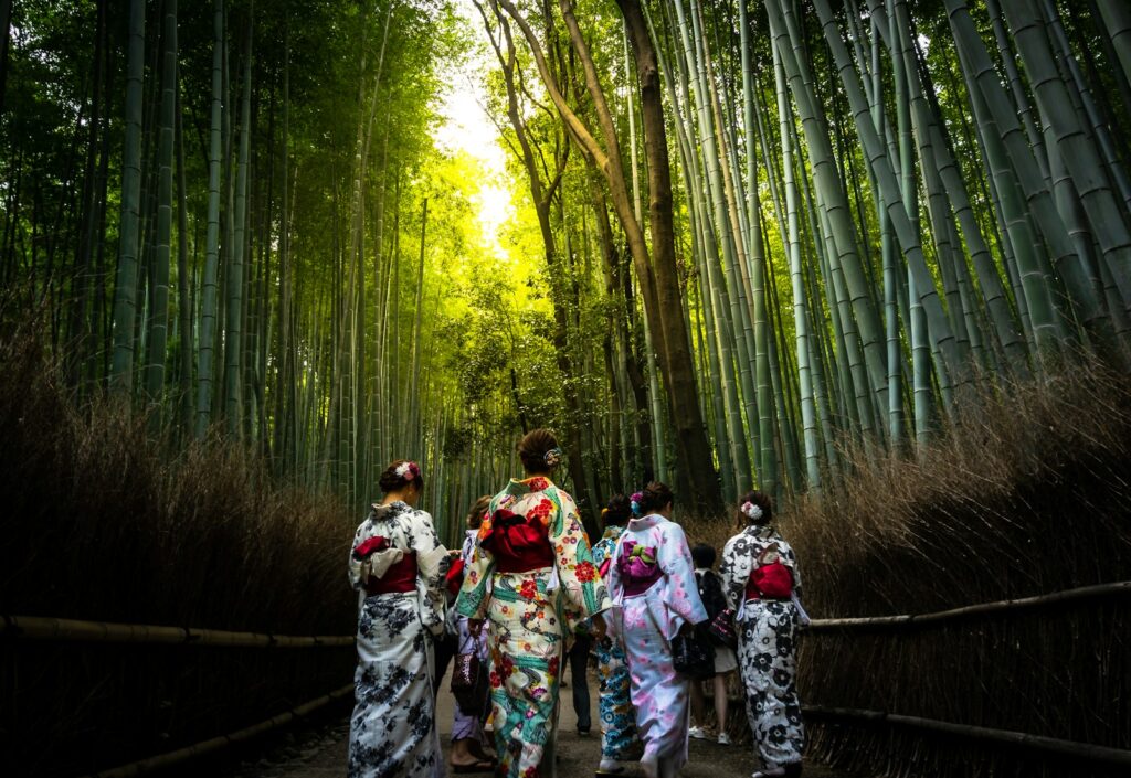 Photo by Gio Almonte geishas in Arashiyama bamboo forest during daytime