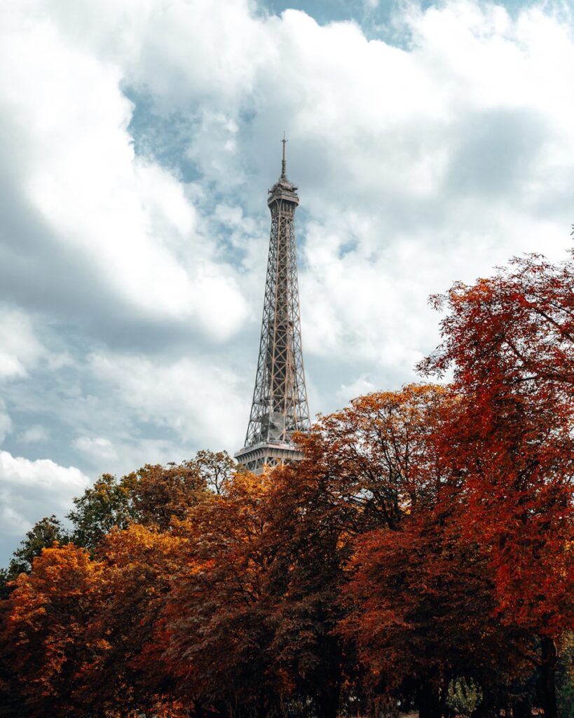 a tall pointy tower with trees around it