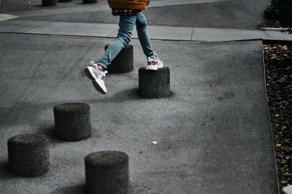 a person walking across a cement walkway