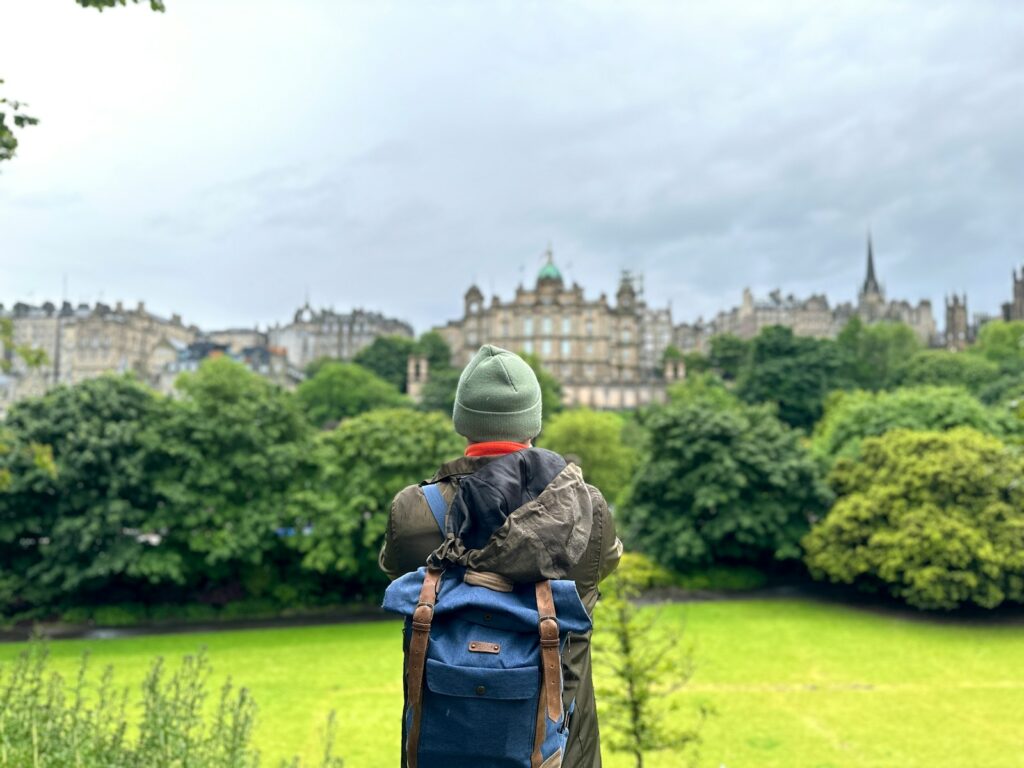 A person with a backpack standing in a field