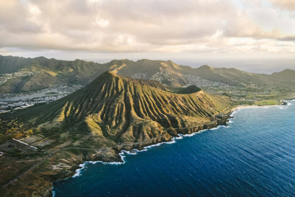 an aerial view of a mountain and the ocean