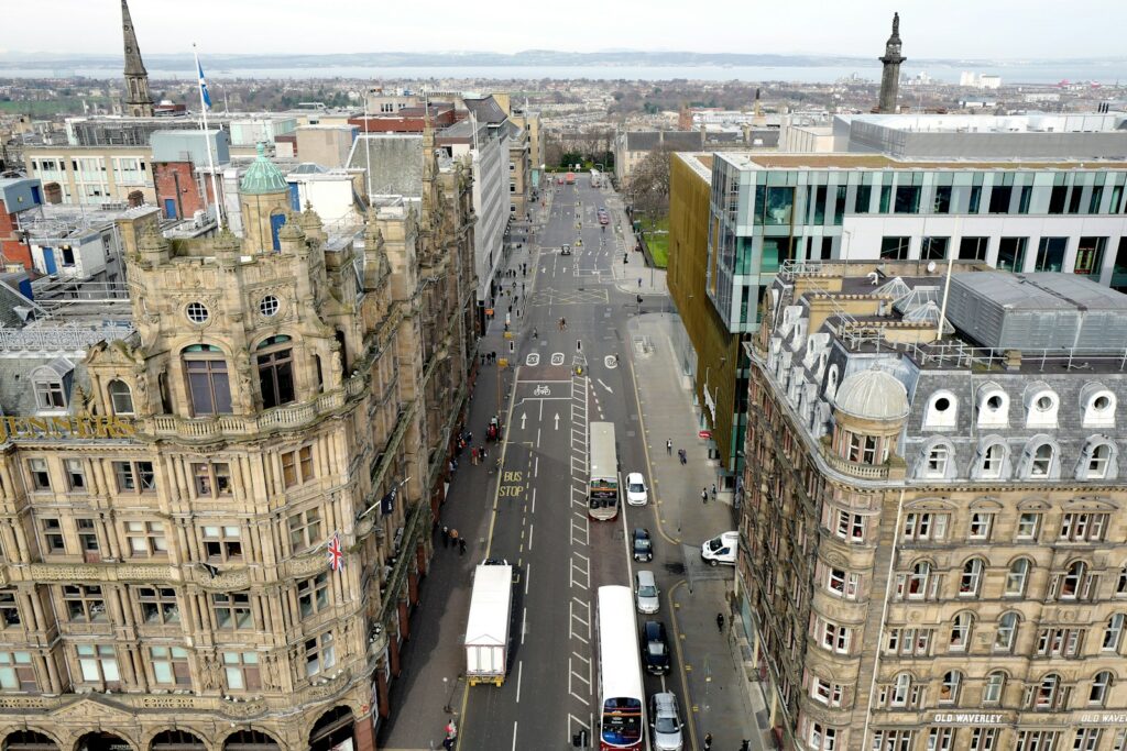 cars on road near high rise buildings during daytime