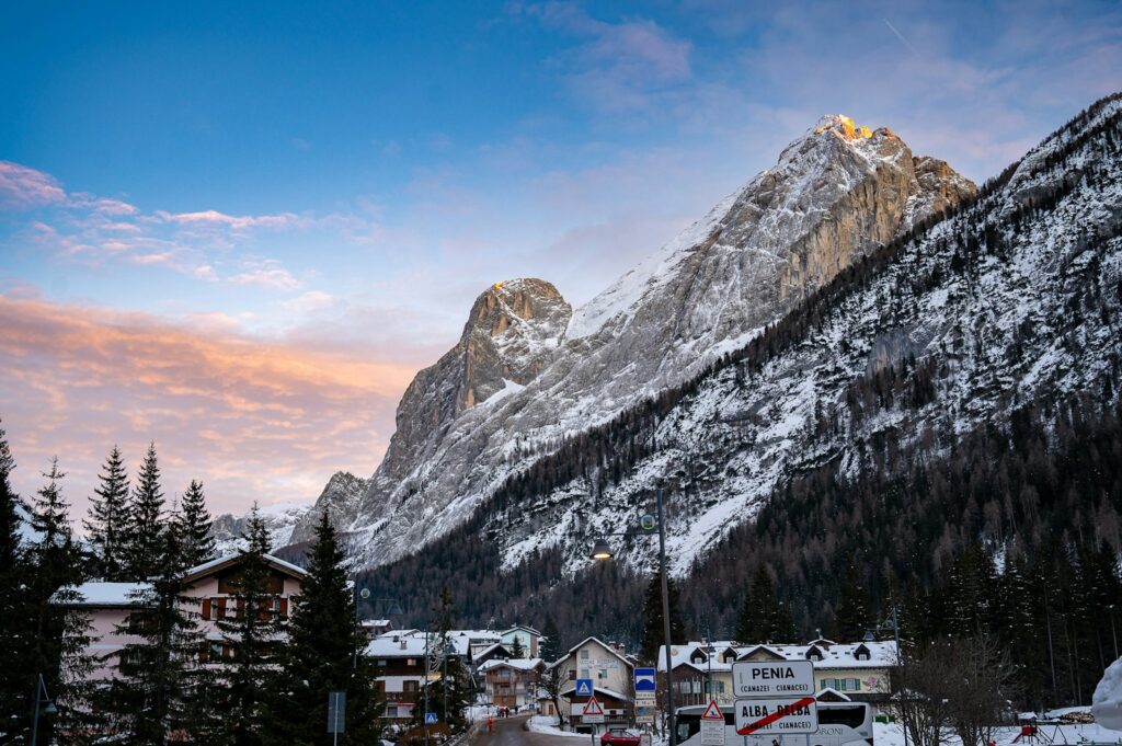 a snowy mountain with a village in the foreground