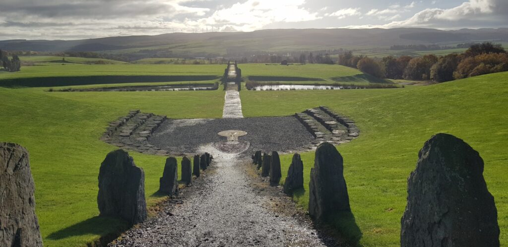 a stone path leading to a grassy field