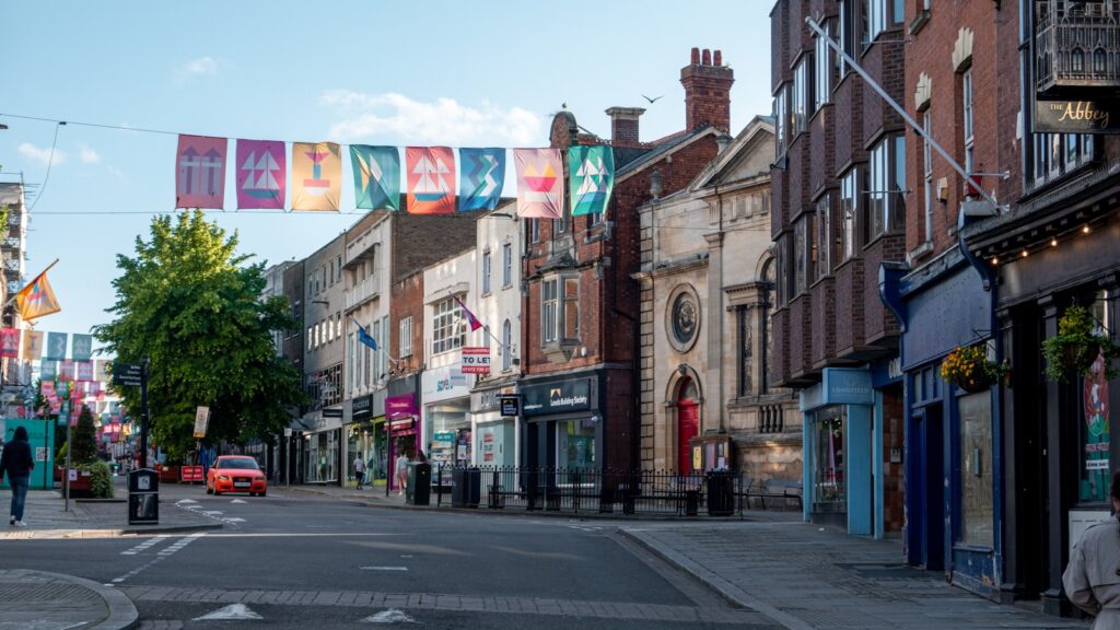 A city street filled with lots of tall buildings