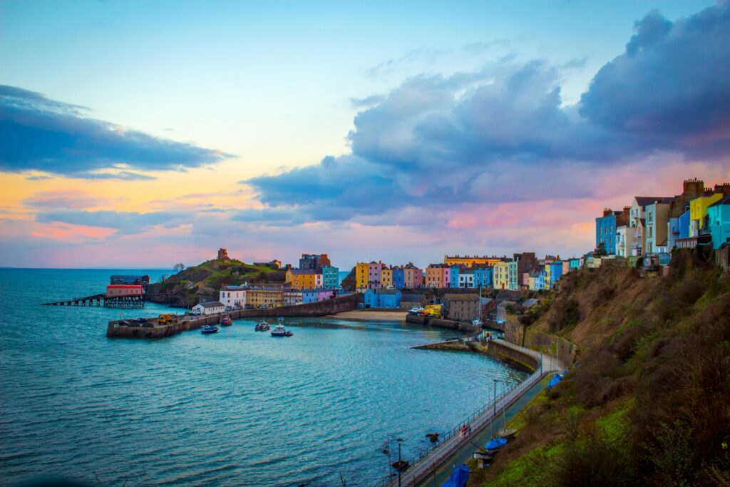multicolored buildings near cove under cloudy sky