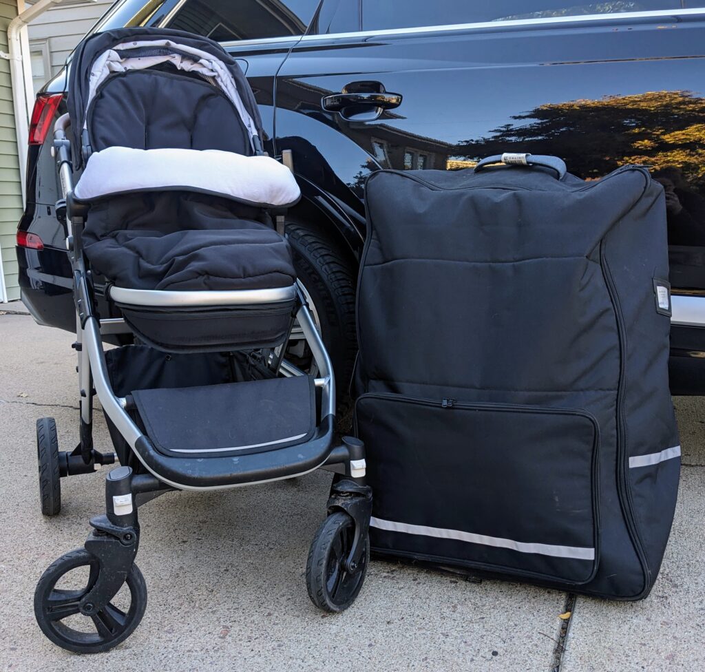 black stroller and a stroller travel bag