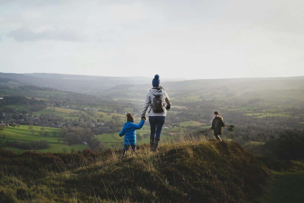 a person with a child walking up a hill